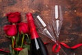 Valentine`s day greeting card with red rose flowers and champagne glasses on wooden background Copy space Top view Royalty Free Stock Photo