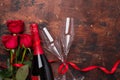 Valentine`s day greeting card with red rose flowers and champagne glasses on wooden background Copy space Top view Royalty Free Stock Photo