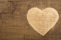 Valentine's Day greetings concept. Heart shape carved on the wood. Valentines greeting card.