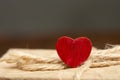 Valentines Day greetings concept. Little red wooden crafted heart and gift box close up on the wooden background. Valentines