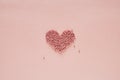 Valentines Day heart made of beads on pale pink background Royalty Free Stock Photo