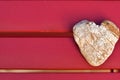 Heart-shaped stone on a red garden table Royalty Free Stock Photo