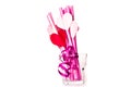 Valentine`s day holiday. bright pink drinking straws with hearts and a pink ribbon in a glass isolated on white.bright sipping st Royalty Free Stock Photo