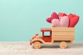 Valentine`s day holiday concept with toy truck and heart shapes