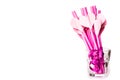 Valentine`s day holiday. bright pink drinking straws with hearts and a pink ribbon in a glass isolated on white. bright sipping s Royalty Free Stock Photo