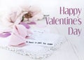 Valentine`s Day image of brightly exposed pink silk roses, cute fortune cookies made of felt and wooden hearts with lace,