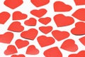Valentine`s day. Lots of red cut out hearts of different sizes on a white background. Royalty Free Stock Photo