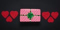 Valentine`s day, love concept. Romantic dark panoramic card with striped white gift box with green bow. Festive present and red Royalty Free Stock Photo
