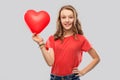 Smiling teenage girl with red heart shaped balloon Royalty Free Stock Photo