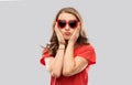 Girl in red heart shaped sunglasses pouting Royalty Free Stock Photo