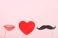 Valentine`s day, love, romantic concept. Red heart, mustaches and lips paper prop on pink background. Greeting card. Flat lay, to Royalty Free Stock Photo