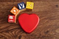 Love spelled with colorful alphabet blocks and a tin Royalty Free Stock Photo