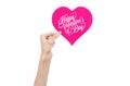 Valentine's Day and love theme: hand holds a greeting card in the form of a pink heart with the words Happy Valentine's day Royalty Free Stock Photo