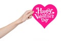 Valentine's Day and love theme: hand holds a greeting card in the form of a pink heart with the words Happy Valentine's day Royalty Free Stock Photo