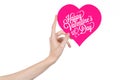 Valentine's Day and love theme: hand holds a greeting card in the form of a pink heart with the words Happy Valentine's day Royalty Free Stock Photo