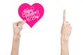 Valentine's Day and love theme: hand holds a greeting card in the form of a pink heart with the words Happy Valentine's day Royalty Free Stock Photo