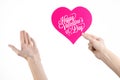 Valentine's Day and love theme: hand holds a greeting card in the form of a pink heart with the words Happy Valentine's day Royalty Free Stock Photo