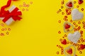 Valentine's Day mock up, yellow background with redhearts and gift box Royalty Free Stock Photo