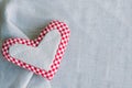 Valentine`s day and mother`s day celebration template. Handmade heart made of canvas and checkered fabric on a linen background Royalty Free Stock Photo