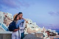 Valentine`s day in Oia. Couple in love enjoying honeymoon on Santorini island Greece at sunset enjoying landscape Royalty Free Stock Photo