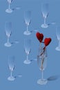 Valentine`s day pattern. Copy image of an empty champagne glass on a light blue background. Royalty Free Stock Photo