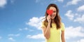 Smiling teenage girl covering her eye by red heart Royalty Free Stock Photo