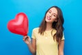 Teenage girl with red heart-shaped balloon Royalty Free Stock Photo