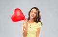 Teenage girl with red heart-shaped balloon Royalty Free Stock Photo