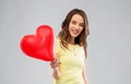 Teenage girl with red heart-shaped balloon Royalty Free Stock Photo