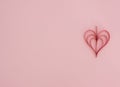Valentine`s Day pink background with handmade quilling red paper heart. Valentine greeting card. Flat lay style with copy space. Royalty Free Stock Photo