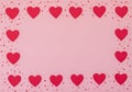 Valentine`s Day pink background with red hearts. Valentine greeting card. Flat lay style with copy space Royalty Free Stock Photo