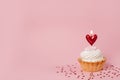 Valentine`s day pink background. Vanilla cupcake decorated red heart candle Royalty Free Stock Photo