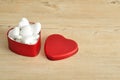 A red heart shape tin filled with hearts Royalty Free Stock Photo