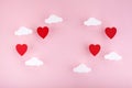 Valentine`s day background. Red hearts and clouds on soft pink background feel like fluffy in the air Royalty Free Stock Photo