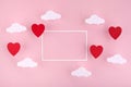 Valentine`s day background. Red hearts and clouds on soft pink background feel like fluffy in the air with white frame Royalty Free Stock Photo