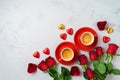 Valentine`s day romantic date concept. Coffee cups, heart shape chocolate and rose flowers on modern background. Top view. Flat