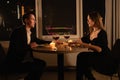 Valentine& x27;s day, romantic dinner candles with wine, couple man and woman have dinner windows and night city background Royalty Free Stock Photo