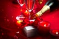 Valentine`s Day romantic dinner. Date. Champagne, candles and gift box over holiday background