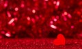 Valentine`s Day. Romantic image in red tones, heart on bokeh background