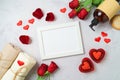 Valentine`s day and romantic spa treatment concept. Mock up frame, rose flowers and candles on bright background. Top view, flat Royalty Free Stock Photo