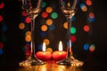 Valentine`s Day, romantic still life, burning candles and glasses on a blurred background, bokeh effect, shallow depth Royalty Free Stock Photo