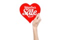 Valentine's Day and sale topic: Hand holding a card in the form of a red heart with the word Sale isolated on white background Royalty Free Stock Photo