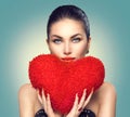 Valentine`s day. girl with heart shaped fluffy red pillow Royalty Free Stock Photo