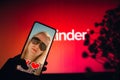 Valentine`s Day, smartphone screen with a photo of a woman in an online dating app