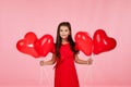Child girl holding red heart shaped balloon Royalty Free Stock Photo