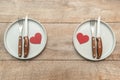 Valentine`s Day tabble serving with plates and silverware on rustic wooden background. Romantic dinner dating concept