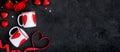 Valentine`s Day table setting with two cups, red ribbon and hearts on dark background Royalty Free Stock Photo