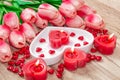 Valentine`s Day Tulips, a heart-shaped plate and a heart-shaped candle. Royalty Free Stock Photo