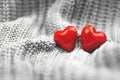 Valentine\'s Day two red hearts background, couple, greeting card and concept of love, blurred, copy space banner, knitted sweater