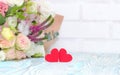 Valentine`s Day. Valentine Gift. Red Hearts and bouquet of flowers on blue wooden background. Beautiful Valentine card art design Royalty Free Stock Photo